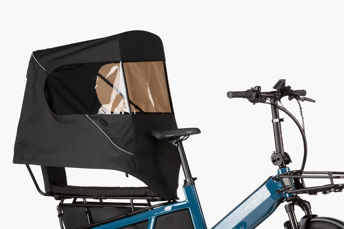 Riese & Müller Multitinker touring in petrol blue/black with safety bar kit and top weather protection close-up.