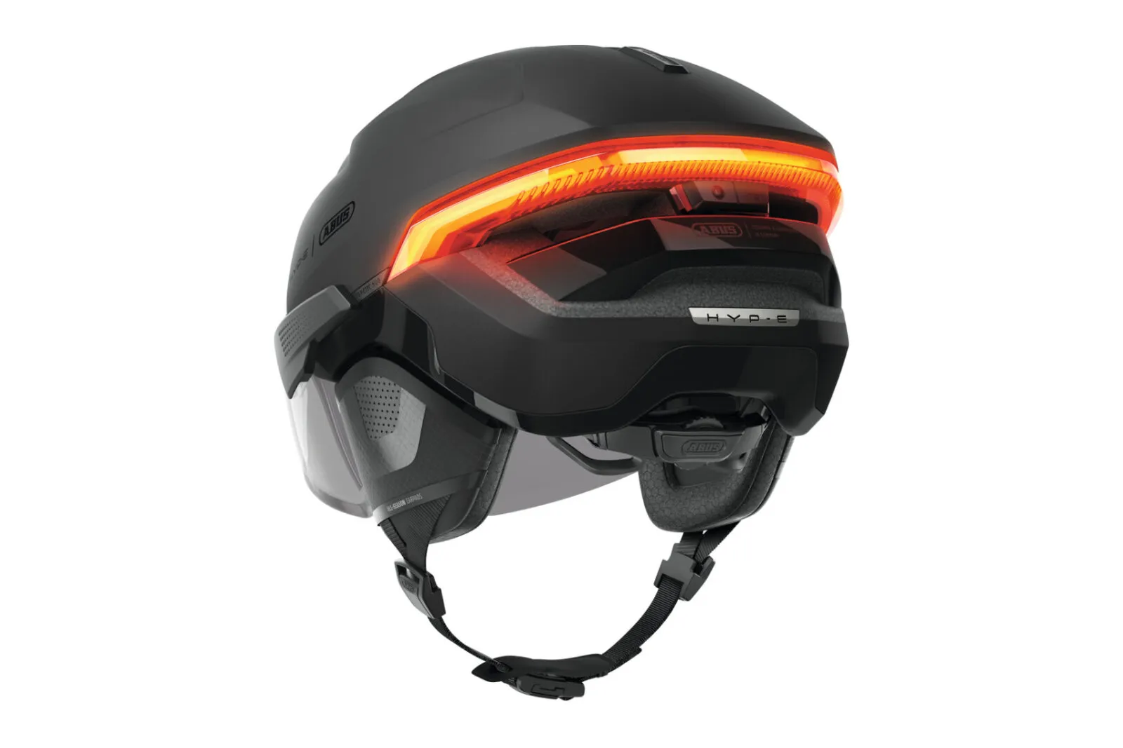 ABUS HYP-E ACE helmet in volcano titan, three-quarter rear view with ear pads fitted