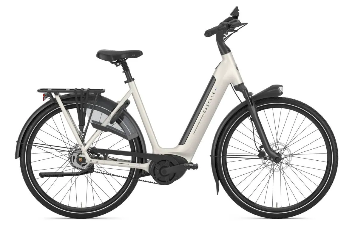Ivory white Gazelle Grenoble C5 e-bike with step-through frame, rear rack and mudguards in profile view.