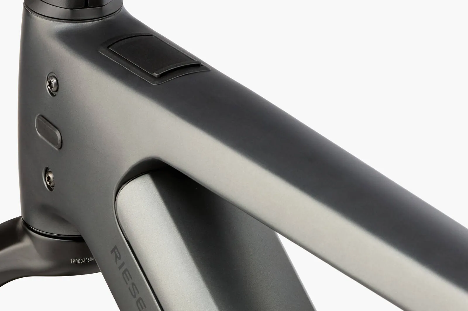 A cyclist riding the Riese & Müller Charger5 through a modern urban environment.