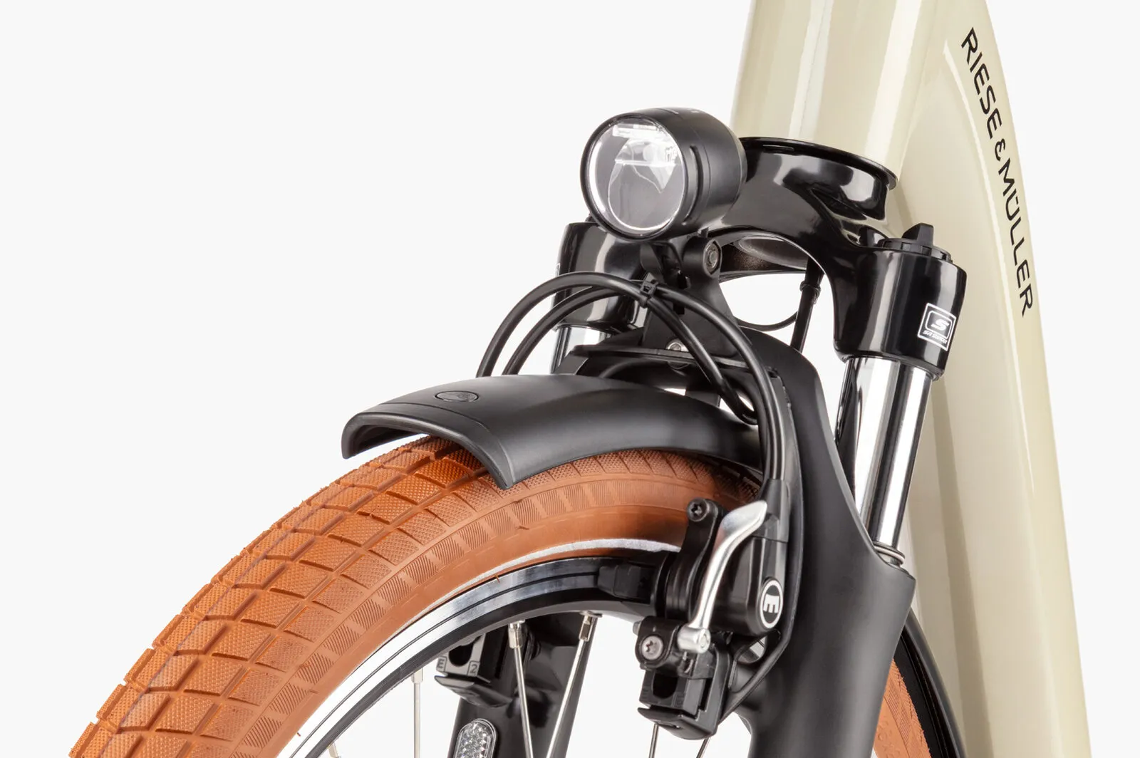 Close-up of the Swing5 front fork, integrated headlight and Magura rim brakes.