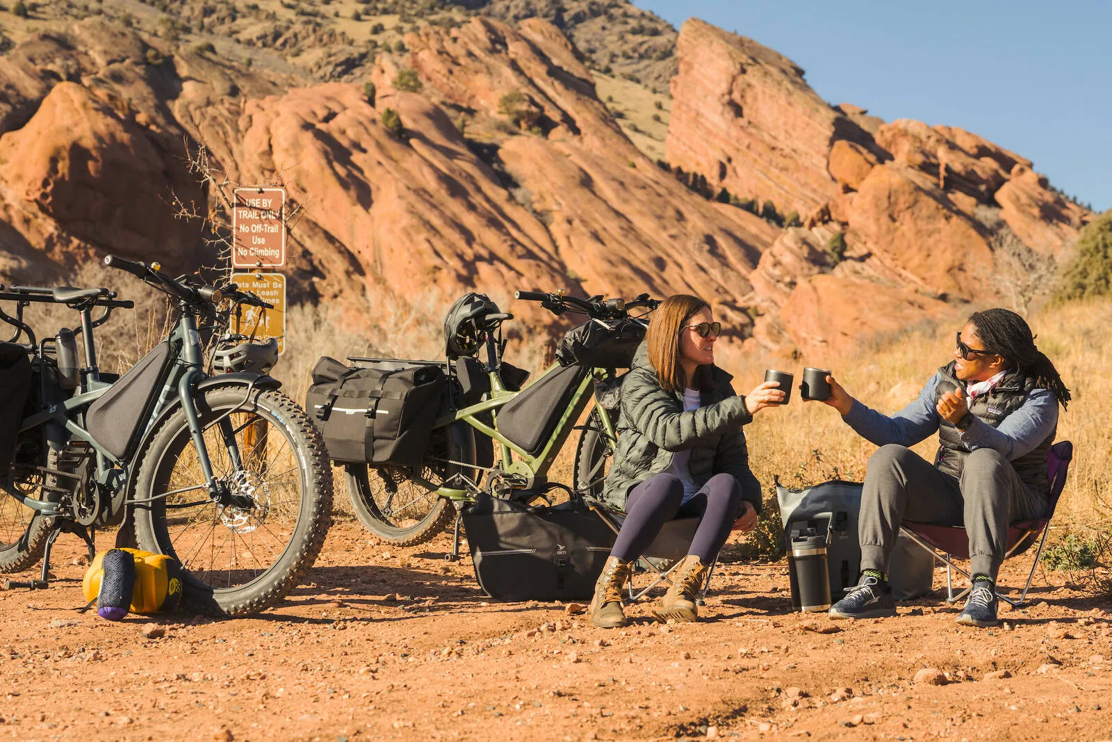 Two people in a desert scene sat next to their Tern Orox bikes