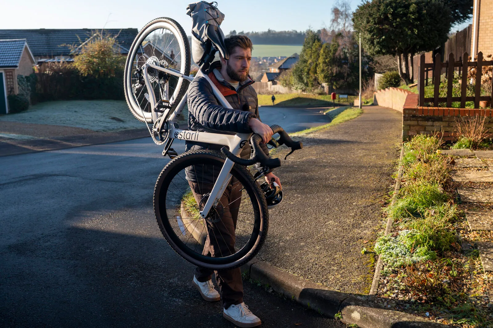 A man carrying the lunar white G700 on his shoulder on a frosty suburban morning.