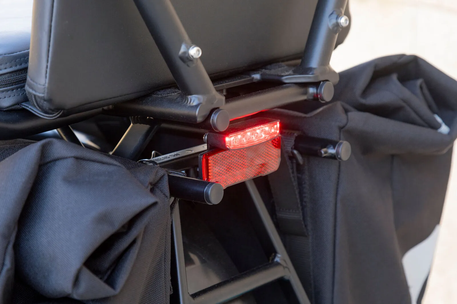 The RearStop brake light glowing red beneath the rear rack of a Tern GSD.