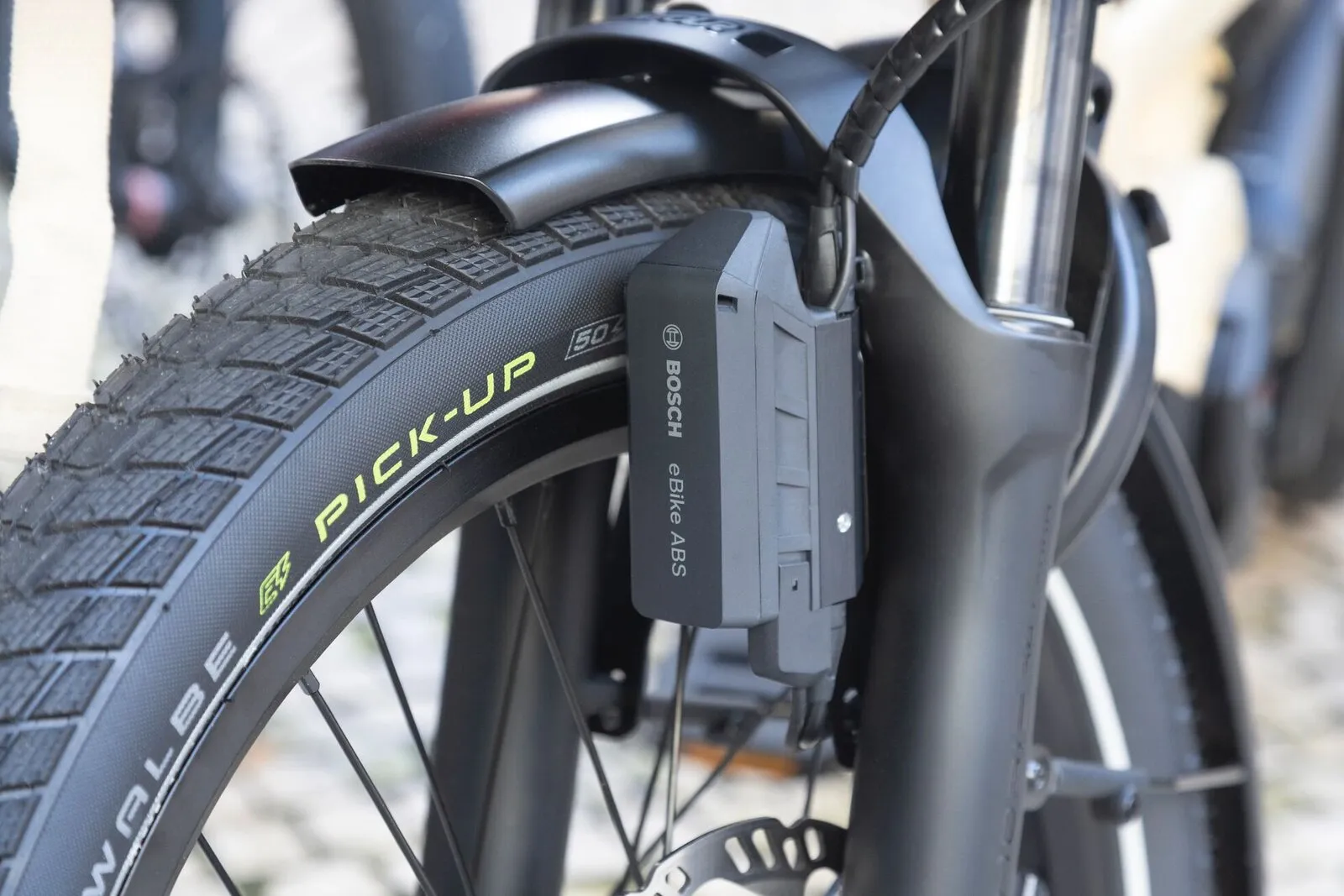 Close-up of the Schwalbe Pick-Up tyre and Bosch eBike ABS unit on the front fork of a Tern GSD.