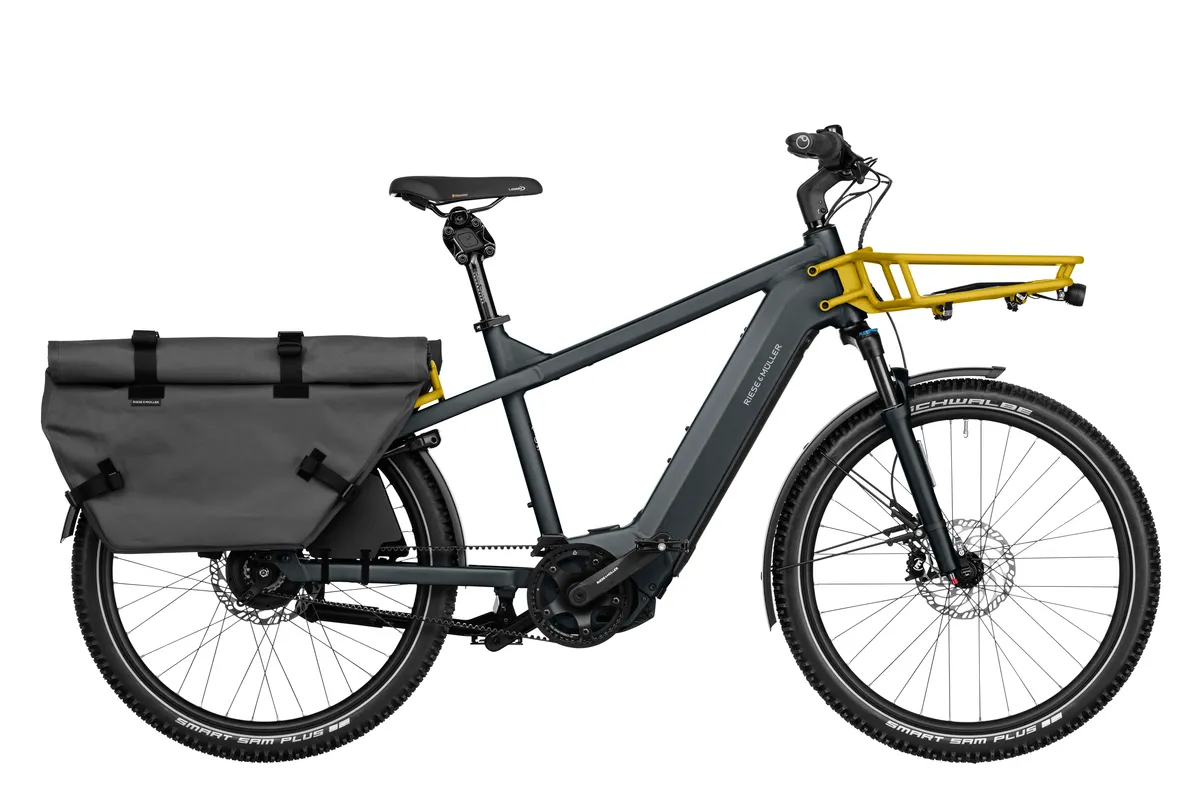 A catalogue photo of the Multicharger2 in utility grey with two large panier bags on the rear rack.