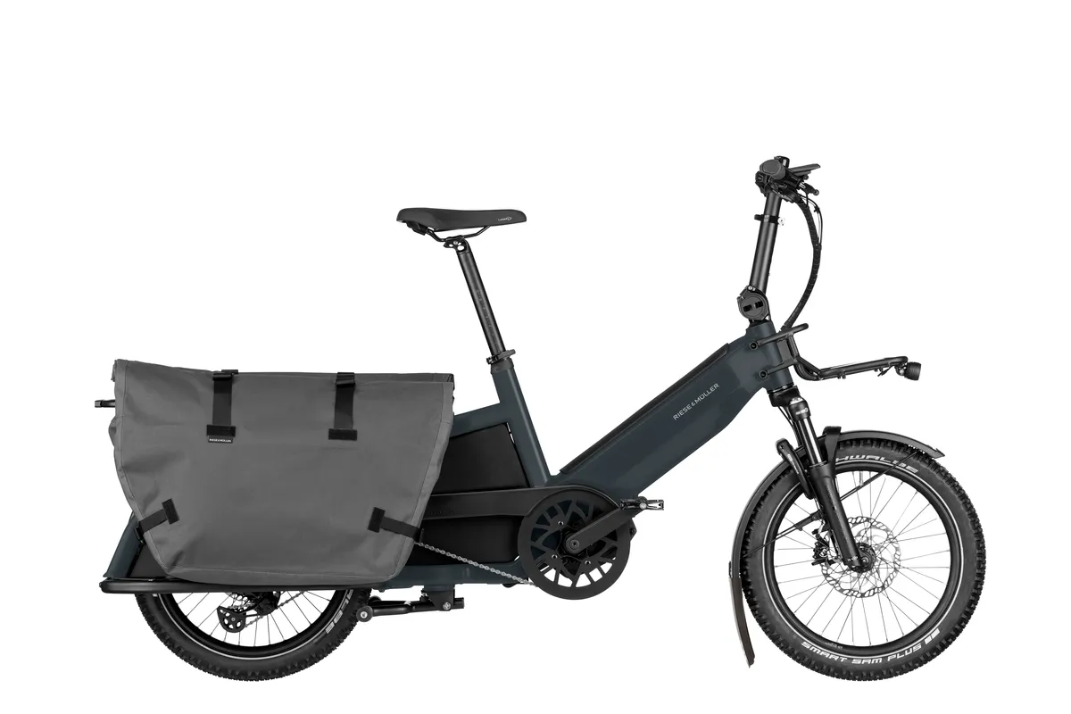 Riese & Müller Multitinker touring in utility grey matt/black with cargo bags and Offroad Kit.