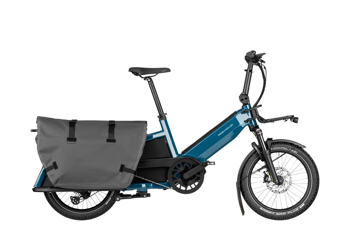 Riese & Müller Multitinker touring in petrol blue/black with cargo bags and Offroad Kit.
