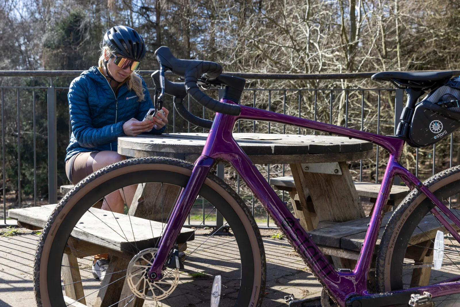 A cosmic purple Estarli G700 leaning against a picnic table during a café stop.